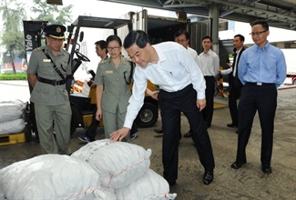 At the Kwai Chung Customhouse, Mr Leung sees for himself the inspection of cargo by Customs officers.