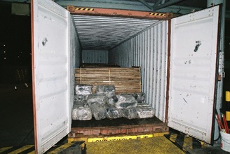 Hong Kong Customs detected a cocaine trafficking case at Kwai Chung Container Terminals on July 4 with a record seizure of about 649 kilograms of cocaine, with an estimated value of about $760 million, from a container arriving from Ecuador. Photo shows the container with wood planks and nylon bags of cocaine slabs.
