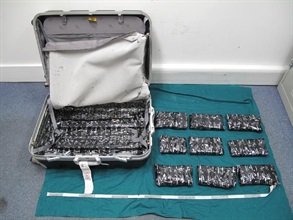 Nine packs of cocaine concealed in the false compartment.