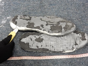 The suspected cocaine concealed in the soles of the shoes.