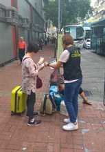The Customs and Excise Department (C&ED) has launched an operation codenamed "Argus" for the October 1 National Day period to enhance consumer protection for tourists, including conducting patrols at shopping hotspots for tour groups as well as at dried seafood shops, drugstores and jewellery shops. Photo shows a Customs officer distributing pamphlets to visitors.