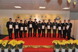 Secretary for Commerce and Economic Development, Mrs Rita Lau (seventh right), and Commissioner of Customs and Excise, Mr Richard Yuen (sixth left), with Hong Kong Customs officers and representatives of organisations who were awarded World Customs Organization Certificates of Merit for their significant contributions to promoting customs-business partnership.