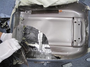The two slabs of cocaine weighing about three kilogrammes in total hidden inside the suitcase.