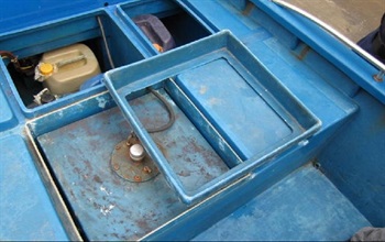 The fuel tank used to cover the concealed compartments of the speedboat.