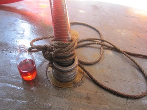 The marked oil is pumped out of the fishing vessel's fuel tank.