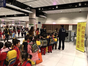 The Customs and Excise Department is very concerned about the use of cross-boundary students (CBSs) for smuggling purposes and will step up customs checks on CBSs, their escorts, and parents travelling with them. Photo shows CBSs using designated clearance passages installed in customs halls.