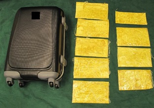 Cocaine concealed in false compartments of a suitcase.
