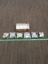 Six packs of suspected methamphetamine seized.