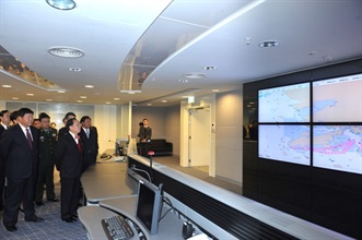 Mr Tsang being briefed by customs officers at the Radio Command Control Room.