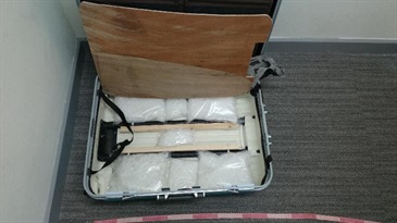 Drugs seized in the false compartment of the suitcase.