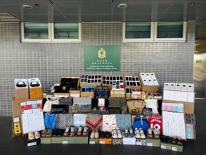 Hong Kong Customs on July 8 seized about 1 900 items of suspected counterfeit goods, including adapters, earphones, mobile phones and clothing, with an estimated market value of about $1 million at the Shenzhen Bay Control Point. Photo shows the suspected counterfeit goods seized.