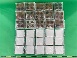 Hong Kong Customs detected two drug trafficking cases involving baggage concealment yesterday (October 5) at Hong Kong International Airport. About 2.1 kilograms of suspected heroin and about 2.1kg of suspected ecstasy, with a toal estimated market value of about $2.1 million, were seized. Photo shows the suspected heroin seized and the mooncakes used for concealment.