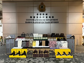 Hong Kong Customs on November 14 seized about 29 000 suspected counterfeit goods and about 34 litres of suspected duty-not-paid liquor at the Tuen Mun River Trade Terminal Customs Cargo Examination Compound. The total estimated market value was about $5.8 million, with a duty potential of about $90,000. Photo shows some of the suspected counterfeit goods and the suspected duty-not-paid liquor seized.