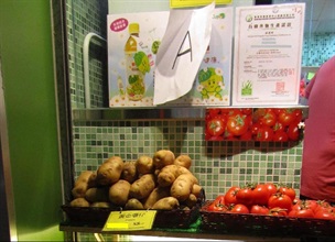 Some of the vegetables falsely labelled as organic on sale at the shop, with a photocopy of the Hong Kong Organic Resource Centre Certification Limited's certificate on display.