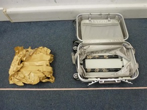 Suspected methamphetamine concealed inside the false compartment of the hand-carry suitcase.