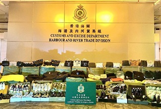 Hong Kong Customs conducted a three-week joint operation with Mainland and Macao Customs from August 24 to September 13 to combat cross-boundary counterfeiting activities among the three places and with goods destined for overseas countries. During the operation, Hong Kong Customs seized about 30 000 items of suspected counterfeit goods with an estimated market value of about $5.5 million. Photo shows some of the suspected counterfeit goods seized, including leather products, clothes and footwear.