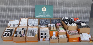 Hong Kong Customs conducted a three-week joint operation with Mainland and Macao Customs from August 24 to September 13 to combat cross-boundary counterfeiting activities among the three places and with goods destined for overseas countries. During the operation, Hong Kong Customs seized about 30 000 items of suspected counterfeit goods with an estimated market value of about $5.5 million. Photo shows some of the suspected counterfeit goods seized, including footwear, mobile phones and accessories.