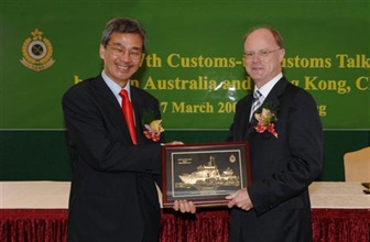 Photo shows Commissioner of Customs and Excise, Mr Timothy Tong exchanging souvenir with the Chief Executive Officer of Australian Customs Service, Mr Michael Carmody (right).