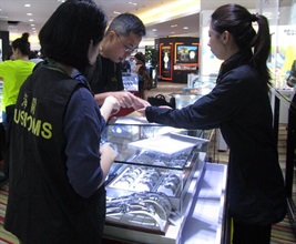 Customs officers conduct a patrol at a shop where visitors are taken by group tour operators.