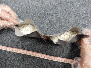 The suspected cocaine concealed in false compartment of the wallet.