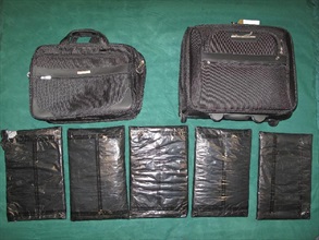 The cocaine was found concealed in the false compartments of the suitcase and the briefcase.