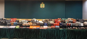 Hong Kong Customs yesterday (February 20) conducted a special operation codenamed "First Clap" and smashed a counterfeiting syndicate in Tung Choi Street, Mong Kok. Five fixed hawker pitches and five storage facilities of suspected counterfeit goods were raided. A total of about 5 000 suspected counterfeit goods including handbags, wallets and scarves with an estimated market value of about $3 million were seized.