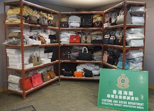 Hong Kong Customs yesterday (February 20) conducted a special operation codenamed "First Clap" and smashed a counterfeiting syndicate in Tung Choi Street, Mong Kok. Five fixed hawker pitches and five storage facilities of suspected counterfeit goods were raided. A total of about 5 000 suspected counterfeit goods including handbags, wallets and scarves with an estimated market value of about $3 million were seized. Photo shows some of the suspected counterfeit goods seized.