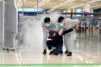 Hong Kong Customs and the Fire Services Department co-organised a counter-terrorism exercise codenamed "GATEKEEPER" yesterday (November 4) afternoon at the Passenger Clearance Building of the Hong Kong-Zhuhai-Macao Bridge Hong Kong Port. Photo shows Customs officers subduing the attacker.