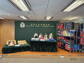 Hong Kong Customs seized about 1 100 items of suspected counterfeit sports footwear and children's clothing with an estimated market value of about $800,000 at Shenzhen Bay Control Point, in Tsuen Wan and in Tsing Yi from October 28 to November 1. Photo shows some of the suspected counterfeit sports footwear and children's clothing seized as well as some of the tools used to pack the suspected counterfeit sports footwear.