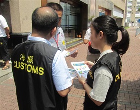 Hong Kong Customs launched an operation codenamed "Bullet" today (April 29) to step up consumer protection work during the Labour Day Golden Week period. Photo shows Customs officers distributing pamphlets in Hung Hom.