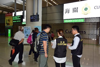 Hong Kong Customs launched an operation codenamed "Bullet" today (April 29) to step up consumer protection work during the Labour Day Golden Week period. Photo shows Customs officers distributing pamphlets at the arrival hall of the Hong Kong-Zuhai-Macao Bridge.