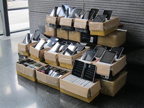 Tablet computers and used mobile phones seized in the operation.