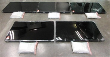 Hong Kong Customs yesterday (November 24) detected two cross-boundary drug trafficking cases through passenger and cargo channels at Hong Kong International Airport and seized a total of about 42.1 kilograms of suspected methamphetamine, ketamine and cocaine, with an estimated market value of over $30 million. Photo shows the five LED television sets used to conceal dangerous drugs and the suspected methamphetamine seized.