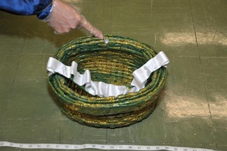 藏有毒品的膠管以紙包裹成條狀並編織成籃子。