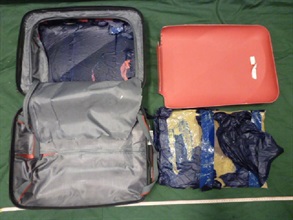 The suspected cocaine seized in the false compartment of the suitcase.