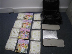 About 6.5kg of heroin was seized from the false compartment of a suitcase and four books by Customs officers.