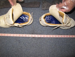 Two slabs of cannabis resin were found concealed under the insoles of shoes.