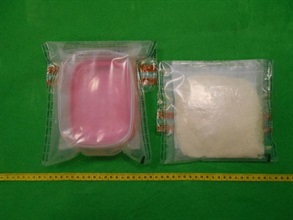 Customs officers inspected an air mail parcel on June 16 and found about 250 grams of suspected ketamine. Photo shows the suspected ketamine seized and the plastic box used to conceal it.