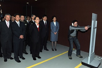 Mr Tsang watches a computer simulated shooting exercise at the Mini Indoor Firing Range.