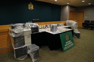 Some of the full-colour copied books, computers and multi-functional photocopiers seized in the operation.