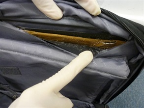 The suspected cocaine was concealed in a false compartment of the suitcase.