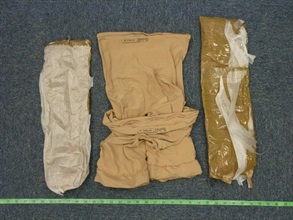 The suspected cocaine was wrapped around the thighs of the arrested person.