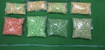 Hong Kong Customs detected four cases of cross-boundary drug trafficking through express parcels at Lok Ma Chau Control Point and Hong Kong International Airport on consecutive days between June 14 and yesterday (June 16). About 23 000 tablets of suspected ecstasy with an estimated market value of about $1.4 million were seized. Photo shows the suspected ecstasy seized in the second case.