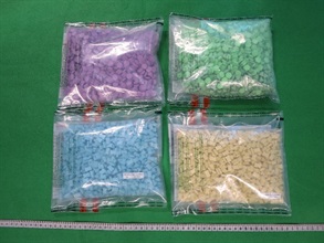 Hong Kong Customs detected four cases of cross-boundary drug trafficking through express parcels at Lok Ma Chau Control Point and Hong Kong International Airport on consecutive days between June 14 and yesterday (June 16). About 23 000 tablets of suspected ecstasy with an estimated market value of about $1.4 million were seized. Photo shows the suspected ecstasy seized in the third case.