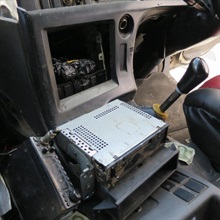 The electronic parts concealed behind the audio player panels in the driving compartment of the container truck.