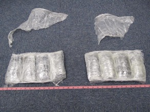 Suspected cocaine packed around the calves of the arrestee.