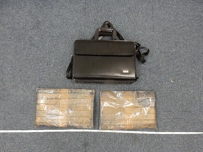 Two slabs of suspected cocaine concealed in the briefcase.