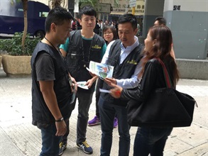Customs officers distribute pamphlets to visitors in Hung Hom.