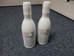 Two massage oil plastic bottles which contained suspected liquid cocaine.