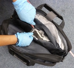 The suspected cocaine soaked in five slabs of cotton pads and concealed inside false compartments of a computer bag.
